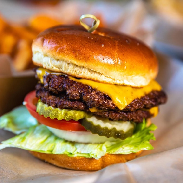 Double smash burger with cheese, lettuce, tomato and pickle