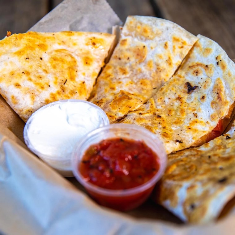 Loaded quesadilla with salsa and sour cream
