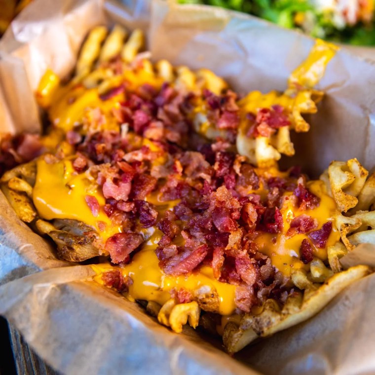 Waffle fries loaded with cheese and bacon