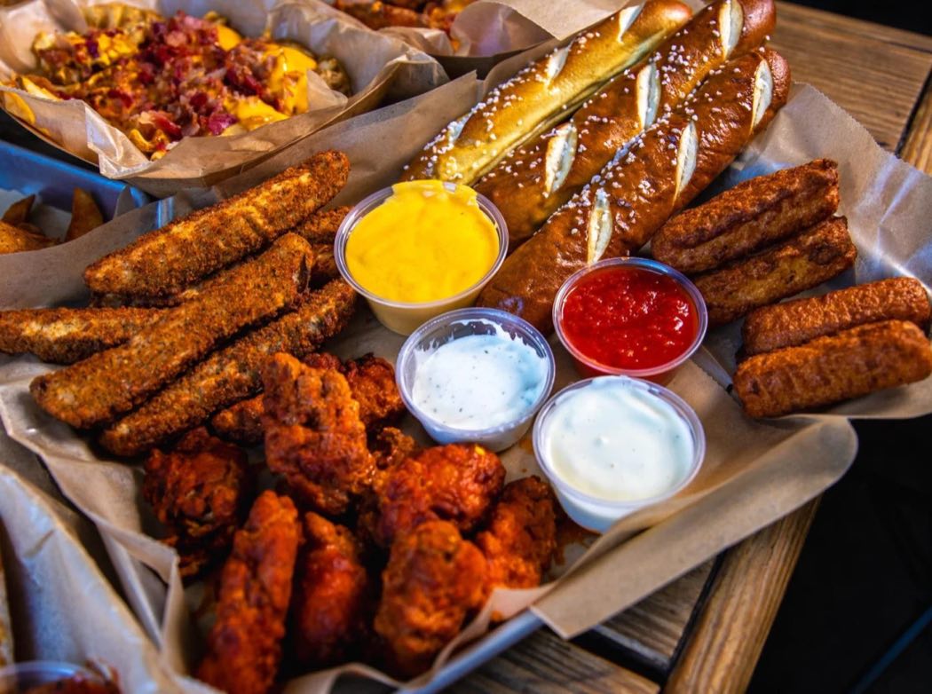 Loaded appetizer sampler platter with wings, pretzels and fried favorites