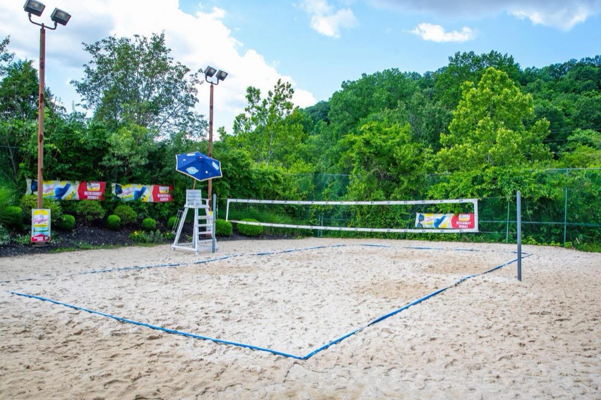 Full-size sand volleyball court at Dickmann's Sports Barn & Brew